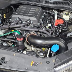 An open car engine with black parts