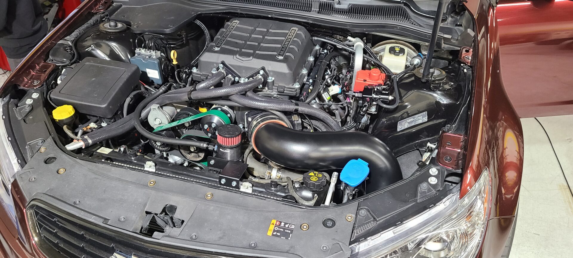 An open car engine with black parts