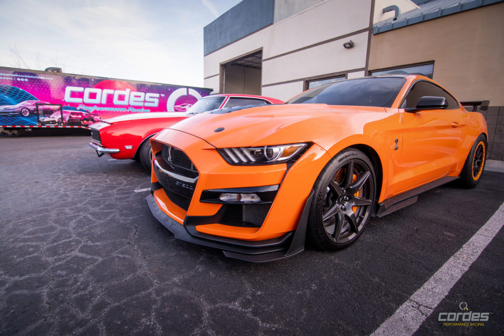 A red sports car and an orange sports car