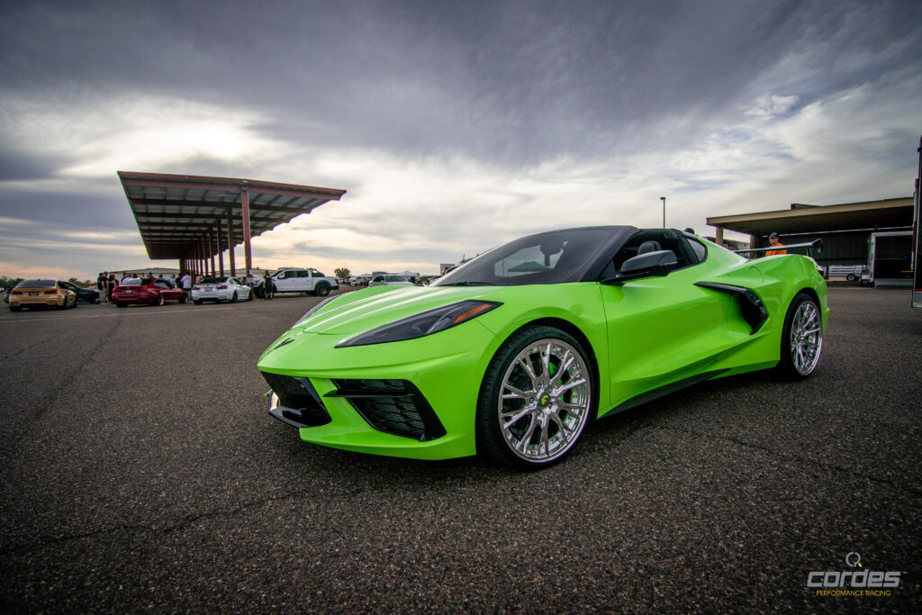 A sleek green sports car in a parking lot