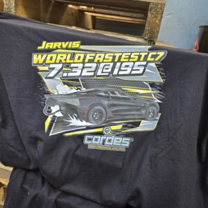 Black jacket with a vibrant racing car design and bold text.