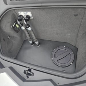 Car trunk with a fire extinguisher and a storage compartment.